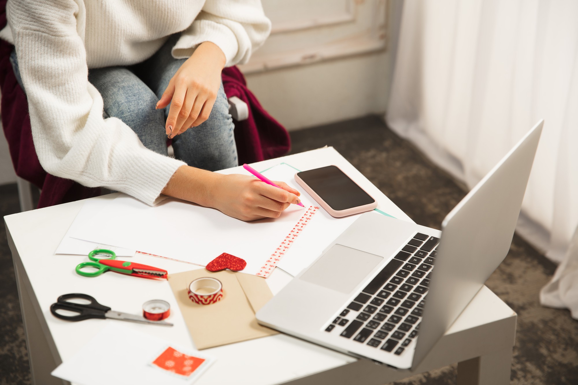 Student stitching at wooden table